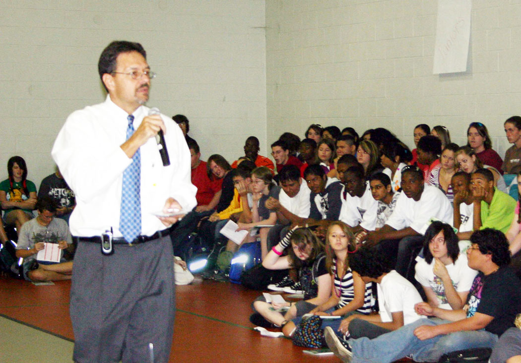 Click to enlarge,  Lee Early College Principal Mark West welcomes students to the college at an assembly Wednesday, the first day of classes. The college, located on Central Carolina Community College's Lee County Campus, is a collaboration between the college and Lee County Schools. Students attend for five years and earn both a high school diploma and an associate degree at no cost to them. 