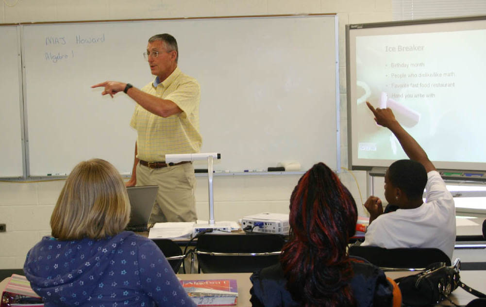 Click to enlarge,  Math teacher John Howard answers students' questions during the first day of classes Wednesday at Lee Early College on Central Carolina Community College's Lee County Campus. The LEC, a collaboration between the college and Lee County Schools, enables students to earn both a high school diploma and an associate degree in five years at no cost to the students. 