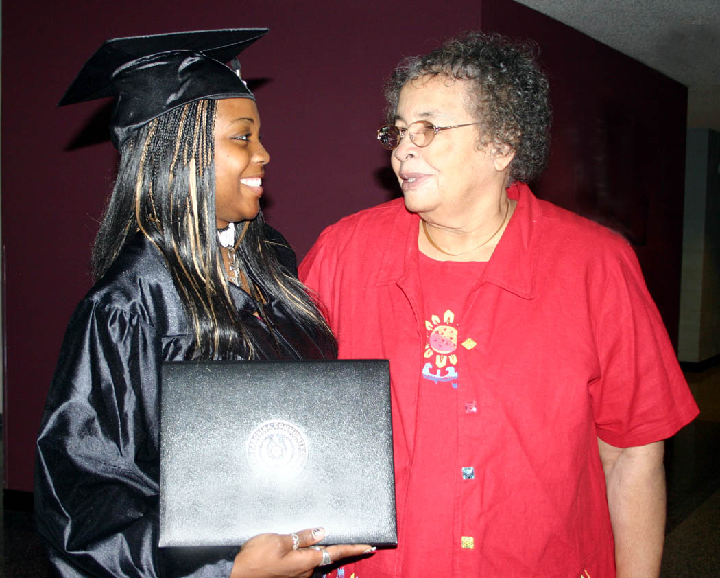Click to enlarge,  Jeannette Reaves (left) , of Bear Creek, gets a big smile from her grandmother, Myrtle Rogers, of Pittsboro, after receiving her Associate in Applied Science in Business Administration degree during Central Carolina Community College&#8217;s Summer Commencement exercises Friday in the Dennis A. Wicker Civic Center. During the summer, 89 students completed degrees, 102 earned diplomas, and 84, certificates. Teddy Byrd, chairman of the Harnett County Board of Commissioners delivered the commencement address. 