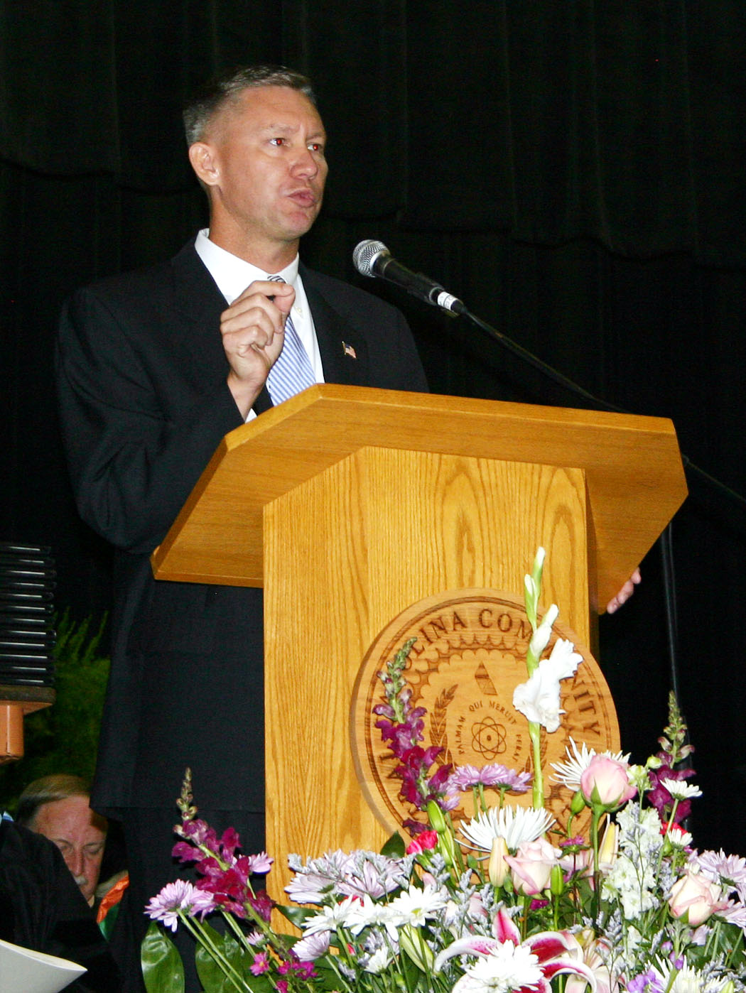 Click to enlarge,  Teddy Byrd, chairman of the Harnett County Board of Commissioners, delivered the commencement address Friday at Central Carolina Community College&#8217;s 45th Annual Summer Commencement Exercises. He urged the graduating class to strive for their best. A crowd of approximately 1,000 family members and friends attended the exercise, held in the Dennis A. Wicker Civic Center, to celebrate the graduating students&#8217; achievements. During the summer, 89 students completed degrees, 102 earned diplomas, and 84, certificates. About 150 graduating students took part in the exercises.  