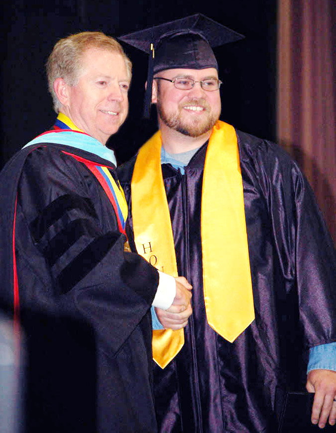 Click to enlarge,  Central Carolina Community College's spring graduation in May was very special to college President Matt Garrett (left). It was his last graduation prior to his retirement Sept. 1 after 21 years with the college, four as president. He also had the joy of seeing his son, M. Steven Garrett Jr. (right), receive his degree in Industrial Systems Technology.  