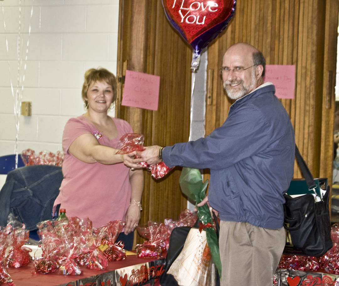 Click to enlarge,  Doreen Fincher (left), a paralegal student from Lillington, helps Steve Lympany, chairman of Engineering Technologies, select some Valentine&#8217;s Day treats for his sweetheart during a Central Carolina Community College SGA fundraiser Feb. 13 at the Lee County Campus. Lympany was in a Valentine mood, purchasing a balloon, candy and flowers.&amp;nbsp; 