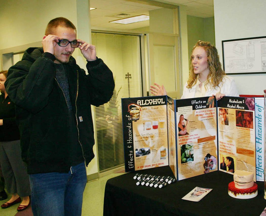 Click to enlarge,  Campbell University School of Pharmacy students put on a Health Fair at Central Carolina Community College&#8217;s Lee County Campus Feb. 18, providing information on high blood pressure, diabetes, substance abuse, cancer, nutrition, and bone density. Central Carolina criminal justice student Samuel Collins ((left), of Sanford, tries out the &#8220;drunk glasses&#8221; that distort visual perception and balance, as excess alcohol does. Describing the effect of the glasses is Doctor of Pharmacy candidate Whitney Deason. The fair was also an opportunity for School of Pharmacy staff to talk to Central Carolina students about the school and its PREP (Pharmacy Readiness &amp;amp; Enrichment Program) that prepares students for it. For more information about PREP, call Dana Martinez at (910) 814-5427 or, toll-free, (800) 760-9734, ext. 5427, or email at  martinezd@campbell.edu . Information is also available online at  www.campbellpharmacy.net  - click on &#8216;PREP.&#8217; For more information about programs at Central Carolina C.C, go online to  www.cccc.edu  or call one of the campuses: Chatham County, (919) 542-6495, Harnett County, (910) 893-9101, Lee County, (919) 775-5401, or toll-free, (800) 682-8353. Campbell and Central Carolina signed an articulation agreement in October, bringing them into a closer educational partnership. 