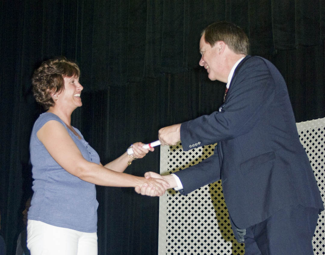 Click to enlarge,  Pharmacy Technician graduate Vanessa Twombly, of Harnett County, receives congratulations and her certificate from Central Carolina Community College President Bud Marchant during the college&#8217;s Lee County Continuing Education Department&#8217;s Medical Programs Graduation May 27 at the Dennis A. Wicker Civic Center. 