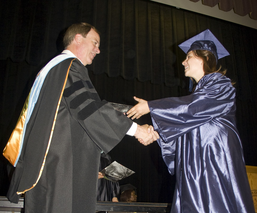 Click to enlarge,  Robin Crim, of Chatham County, receives her Adult High School diploma from Central Carolina Community College President Bud Marchant during the college&#8217;s Adult High School and General Educational Development commencement exercises June 18 at the Dennis A. Wicker Civic Center. Approximately 190 adults completed high school or a GED through the college&#8217;s adult education program during the spring semester. 