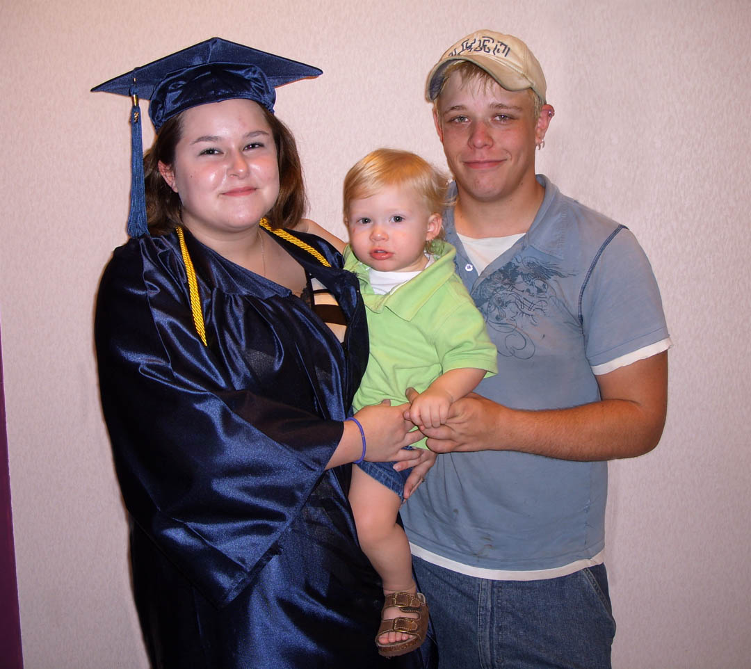 Click to enlarge,  Jesse Poole (left), of Harnett County, celebrates her high school graduation with her husband, Tommy Smith, and their son, Marley, at Central Carolina Community College&#8217;s Adult High School and General Educational Development graduation exercises June 18 at the Dennis A. Wicker Civic Center. Smith said that his wife has inspired him to go back and get his own diploma. Approximately 190 adults completed high school or a GED through the college&#8217;s adult education program during the spring semester. 