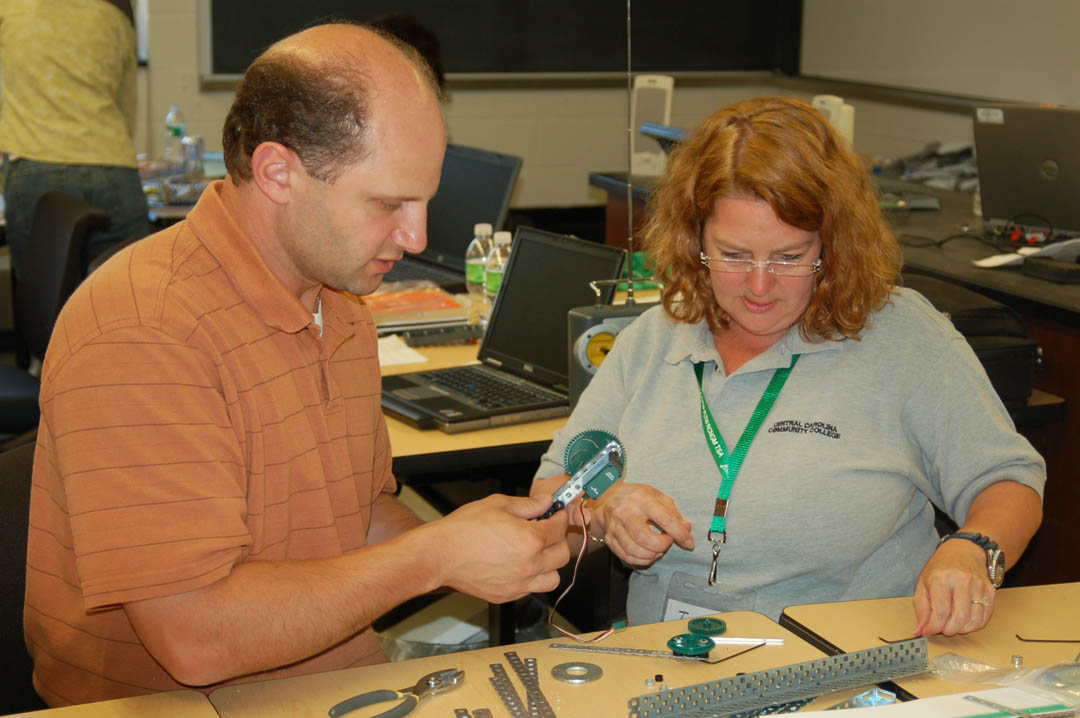 Click to enlarge,  Jamie Tyson (right), Central Carolina Community College Electronics instructor and High School Cooperative Programs coordinator, and Alan Tancreti, a Connecticut high school teacher, assemble a watercraft robot during &#8216;An Engineering Challenge for the 21st Century,&#8217; a Teacher&#8217;s Dissemination Program held July 12-17 at the U.S. Coast Guard Academy, New London, Conn. Twenty-four high school and community college instructors from around the nation took part in the program, which was sponsored by the Academy and a National Science Foundation grant to Connecticut Community Colleges&#8217; College of Technology and Next Generation Regional Manufacturing Center. The instructors practiced teaching techniques to guide students in developing skills to become engineers and technicians, including problem-based robotic projects, effective teamwork, professional skills, interpersonal skills, and personal accountability. During the &#8216;Challenge,&#8217; they also weighed and hoisted anchor aboard a Coast Guard tug vessel, used a ship simulator to command a vessel, beach seined, and took part in an earthquake survival simulation.&amp;nbsp; 