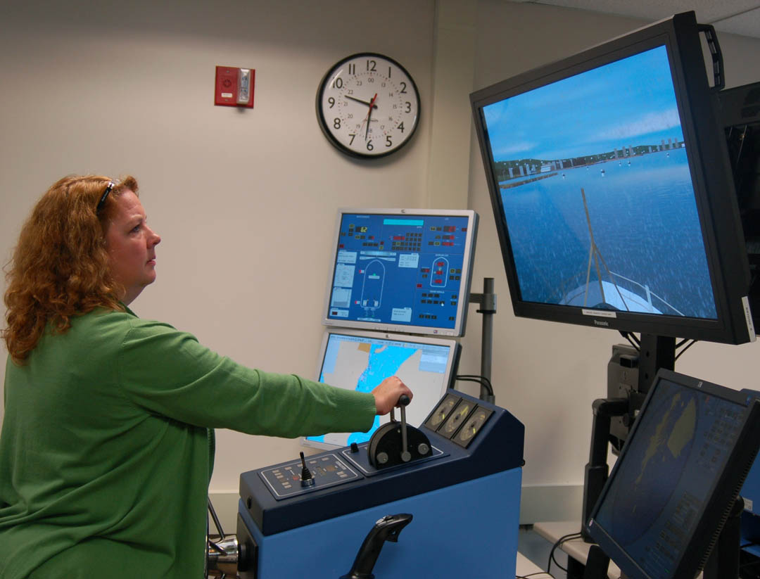 Click to enlarge,  Jamie Tyson, Central Carolina Community College Electronics instructor and High School Cooperative Programs coordinator, uses a simulator to practice navigating a 110-foot Coast Guard Cutter assisting a nuclear submarine to port. The simulation took place during &#8216;An Engineering Challenge for the 21st Century,&#8217; a Teacher&#8217;s Dissemination Program held July 12-17 at the U.S. Coast Guard Academy, New London, Conn. Only Tyson and one other person completed the simulation successfully. Twenty-four high school and community college instructors from around the nation took part in the program, which was sponsored by the Academy and a National Science Foundation grant to Connecticut Community Colleges&#8217; College of Technology and Next Generation Regional Manufacturing Center.&amp;nbsp; The instructors practiced teaching techniques to guide students in developing skills to become engineers and technicians, including problem-based robotic projects, effective teamwork, professional skills, interpersonal skills, and personal accountability. During the &#8216;Challenge,&#8217; they also weighed and hoisted anchor aboard a Coast Guard tug vessel, beach seined, took part in an earthquake survival simulation, and did robot construction of a watercraft related to Coast Guard missions.&amp;nbsp; 