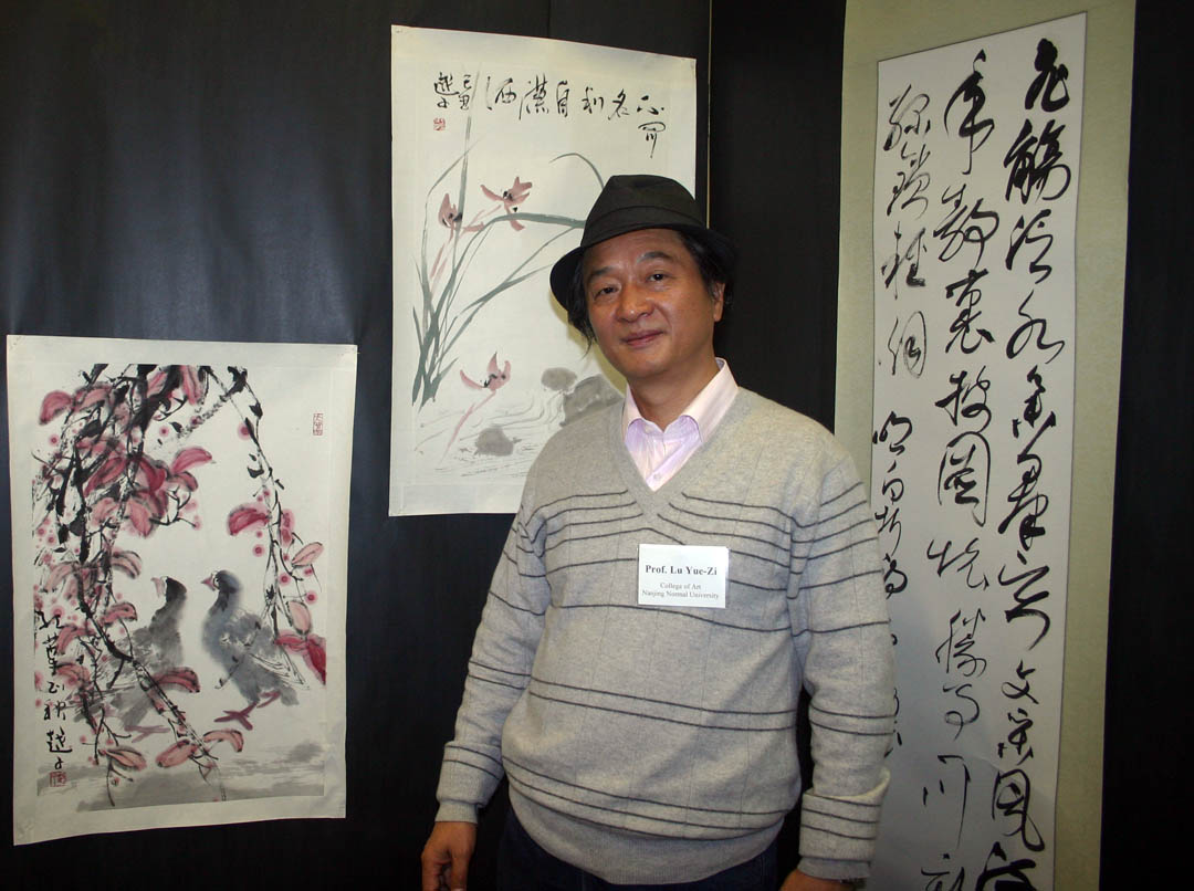 Click to enlarge,  Professor Yue-zi Lu and four other faculty of the College of Fine Arts at Nanjing Normal University in the People&#8217;s Republic of China, exhibited their traditional Chinese paintings and calligraphy Thursday at the McSwain Center in Sanford. Lu was one of five artists in the exhibition hosted &amp;nbsp;by Central Carolina Community College. The event was made possible by the partnership between CCCC&#8217;s Confucius Classroom and North Carolina State University&#8217;s Confucius Institute, a center for the teaching of Mandarin Chinese and the sharing of Chinese culture. 