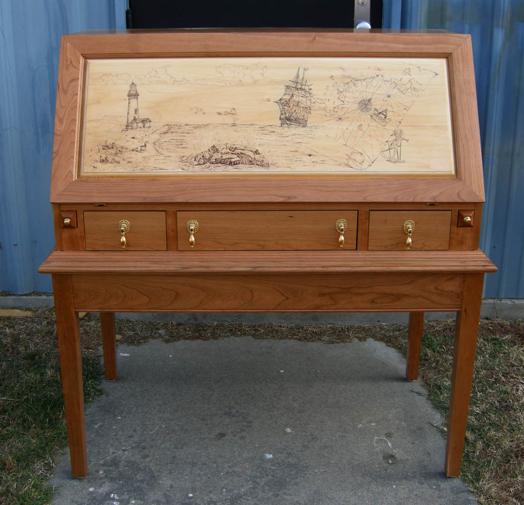 Click to enlarge,  A unique desk with an attractive coastal scene on its slanted front is one of more than 100 handcrafted wood and metal items available at the Central Carolina Community College Foundation Furniture Auction June 5. Proceeds from the Auction primarily fund a scholarship endowment for Harnett County students at the college. The Auction takes place in the Multipurpose Room of the Miriello Building on the college&#8217;s Harnett County Campus, 1075 E. Cornelius Harnett Blvd., Lillington. Viewing starts at 11 a.m. and bidding, at 12 p.m. For more information on the Auction, call the Harnett County Campus, (910) 893-9101. See pictures of the items being auctioned at the college&#8217;s web site,  www.cccc.edu . Click on the right arrow next to the &#8220;Learn More&#8221; boxes and then click on the Foundation Furniture Auction box. 