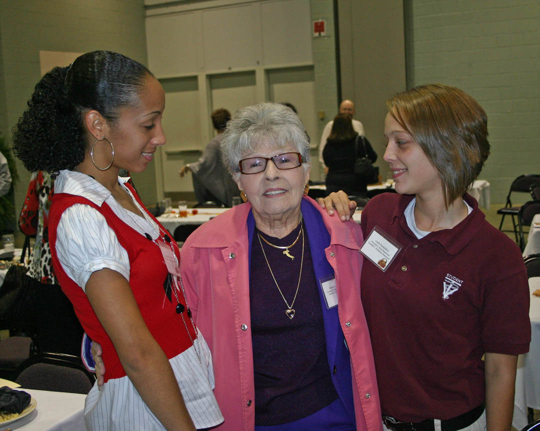 Click to enlarge,  Several hundred scholarship donors and recipients gathered Nov. 16 at the Dennis A. Wicker Civic Center, in Sanford, for the Central Carolina Community College Foundation Scholarship Luncheon. The luncheon provided an opportunity for the donors to become personally acquainted with those they are helping and enabled the recipients to thank them in person. Marie C. Profio (center), of Sanford, endowed two scholarships: the Everette T. Hickman Memorial, in memory of her first husband, and the Samuel C. Profio Memorial, in memory of her second husband. Office administration student Jasmine Corletto (left), of Sanford, received the Profio scholarship and veterinary medical technology student Leah Hamilton (right), of Erwin, received the Hickman scholarship to help them pay for their college educations. For information on establishing scholarships or endowments, contact the CCCC Foundation at (919) 718-7231 or  dglover@cccc.edu . 