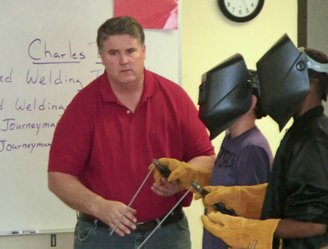 Click to enlarge,  Charles Bell (left), Central Carolina Community College certified welding instructor, shows Overhills Middle School students Brendan Stone (center) and T.J. Allen the type of equipment they would work with if they chose a career in welding. Students from Overhills were at the college's Harnett County Campus, in Lillington, April 13 for a tour of the facility and to learn about various vocational and technical career study paths the college offers. For more information on the college&#8217;s programs, visit its web page,  www.cccc.edu .&amp;nbsp; 