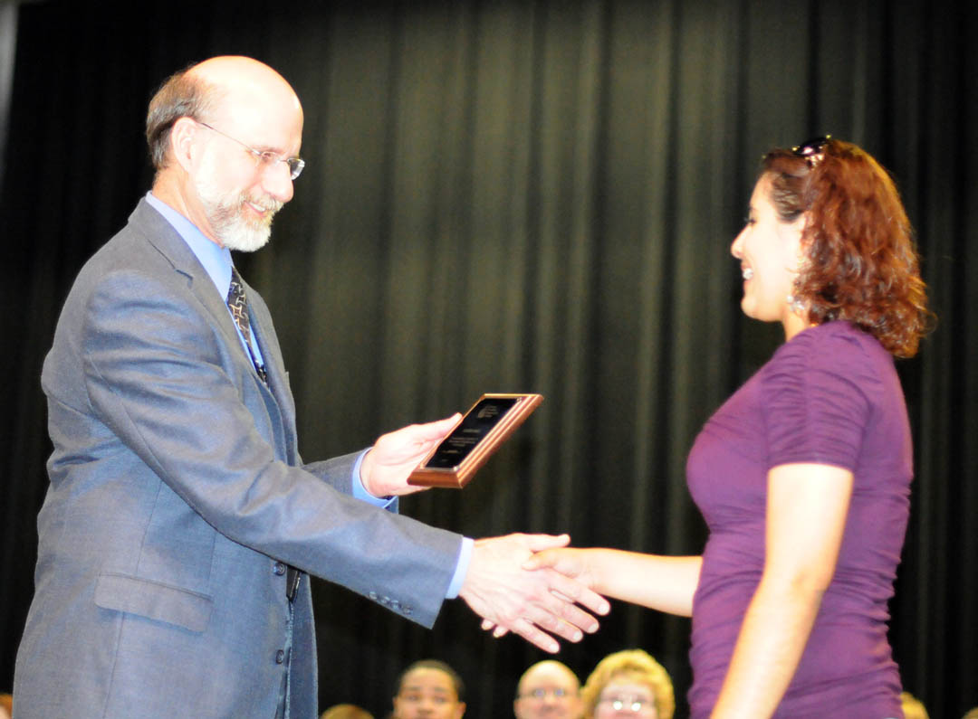 Click to enlarge,  Central Carolina Community College honored 72rnoutstanding graduating curriculum students during its 16 th  AnnualrnAcademic Excellence Awards Night May 4 at the Dennis A. Wicker Civic Center.rnKaren Diaz (right), of Harnett County, accepts the award for OutstandingrnStudent in Electronics Engineering Technology from Steven Lympany, chair of therncollege&#8217;s Engineering Technology Department. 