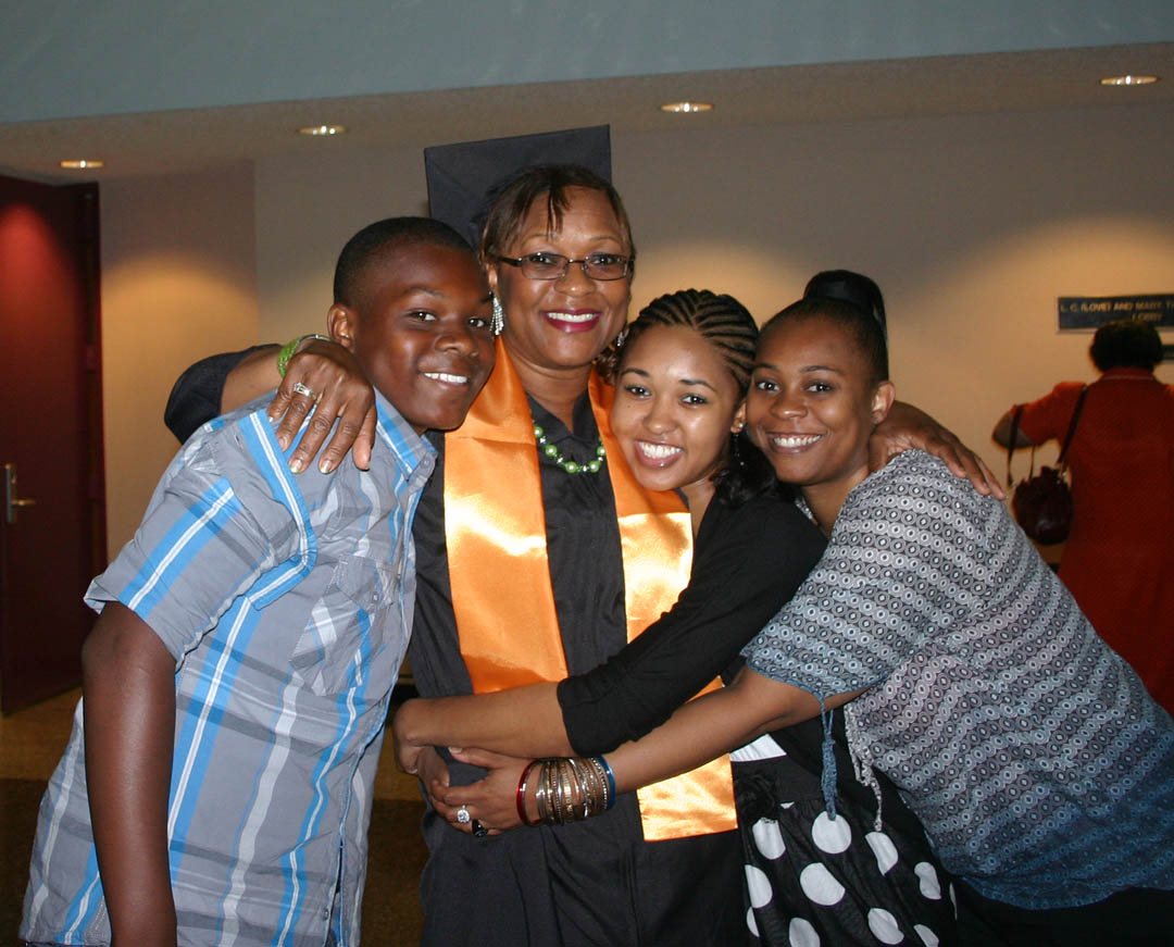Click to enlarge,  Lora Bradley (center), of Chatham County, gets a congratulatory hug from her grandson B.J. Harrington (left) and daughters (right) Brittany Bradley and Tiffaney Cross following the May 17 Central Carolina Community College spring graduation, held at the Dennis A. Wicker Civic Center. Bradley, who received her Associate in Applied Science in Human Services Technology, was among the more than 300 graduating students who attended either a morning or afternoon graduation exercise. Almost 1,000 associate degrees, diplomas and certificates were earned by the Class of 2011.&amp;nbsp; 