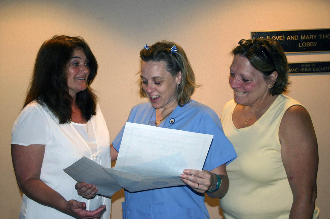 Click to enlarge,  Meredith Repko (center), of Lee County, shares the joy of receiving three certificates during the May 18 Medical Programs Graduation for Central Carolina Community College&#8217;s Continuing Education Department with her EKG instructor Diane Oldham (left) and mother, Becky Owens. Repko earned her EKG Technician, Advanced EKG Technician and Nursing Assistant I certficates in fulfillment of a promise made to her son, Corey, who died in 2009. More than 100 students earned certificates in various medical programs, with some earning more than one. About 50 attended the graduation ceremony. 