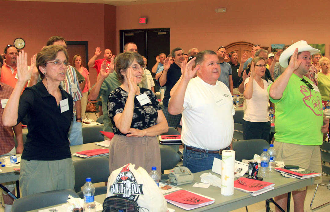 Click to enlarge,  Students in Central Carolina Community College&#8217;s June 11 Barbeque Judging class raise their arms to the square to recite the Kansas City Barbeque Society&#8217;s Official Judge&#8217;s Oath after completing the 4.5-hour class at the college&#8217;s Harnett County Campus. Don Harwell, vice president of the KCBS, taught the class how to judge various types of chicken, pork, ribs and brisket barbecue. The Continuing Education class attracted 55 people from North and South Carolina, Virginia, Pennsylvania, Georgia, and Florida. For more information about Continuing Education classes, visit the CCCC Web site at  www.cccc.edu  and click on &#8220;Continuing Education.&#8221; 