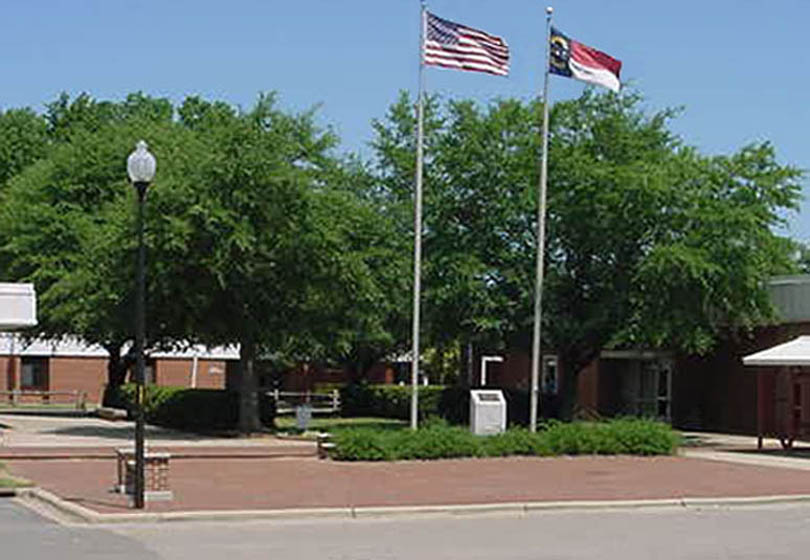 Click to enlarge,  For years, the trees and hedges at the main entrance to Central Carolina Community College&#8217;s Lee County Campus formed a visual barrier to the campus, rather than an inviting entry, as shown in this photograph taken last year before redesign work was done.&amp;nbsp; 