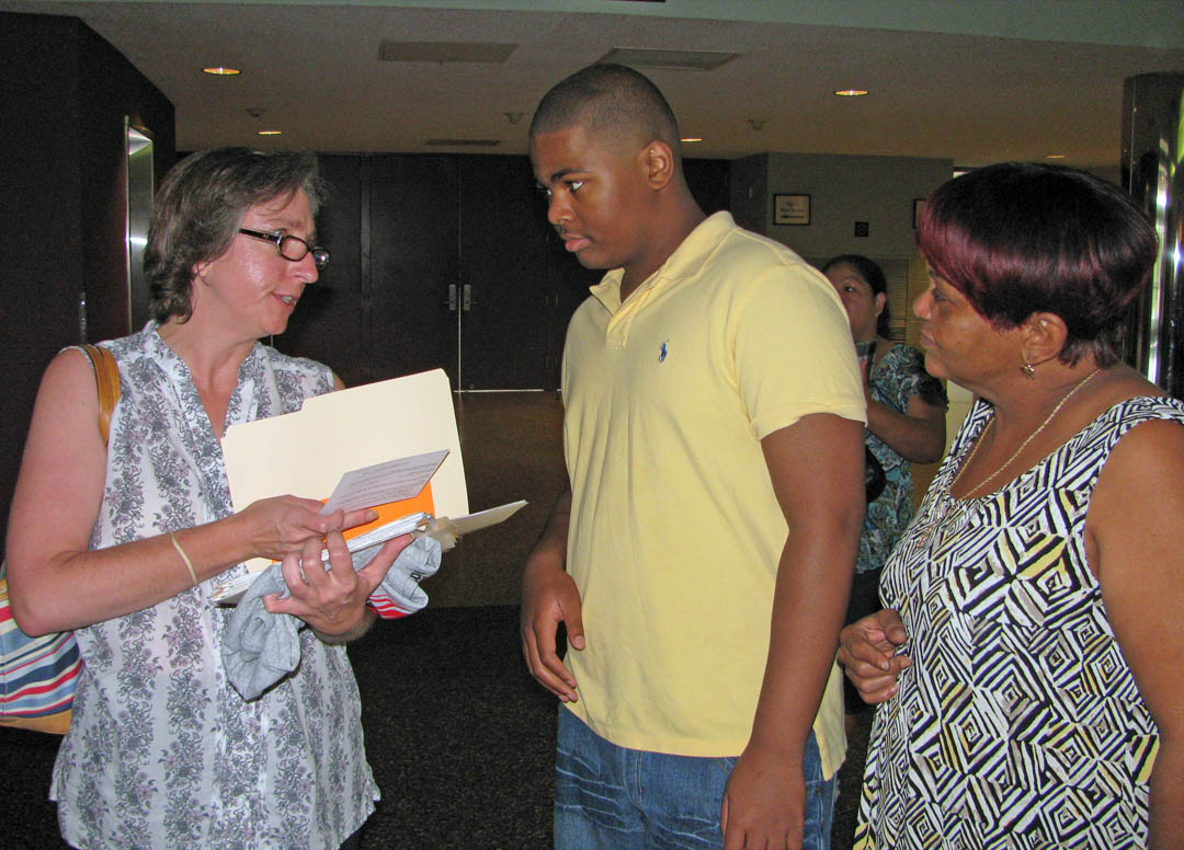 Click to enlarge,  Sharon Christensen (left), math teacher, speaks with an incoming Early Lee College freshman and his mother at the school's freshman orientation August 3 at the Dennis A. Wicker Civic Center. LEC, located on the Lee County Campus of Central Carolina Community College, is a partnership between the college and Lee County Schools. Students enroll as ninth graders and, within five years, earn both a high school diploma and an associate degree. For more information about LEC's program, visit www.leeearlycollege.com.  