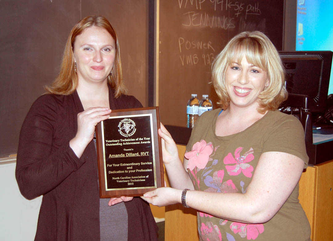 Click to enlarge,  N.C. Association of Veterinary Technicians President Amanda Dillard (left), of Randleman, receives the association's Veterinary Technician of the Year award from Vice President Beckie Mossor (right), of Sanford, during the organization's spring conference March 10 at N.C. State University's College of Veterinary Medicine. Both are graduates of Central Carolina Community College's Veterinary Medical Technology program. Dillard was honored for years of hard work and dedication to the association while serving on its board. At the conference, she was voted in as the organization's 2012-13 president. For more information about CCCC's five-semester Veterinary Medical Technology associate degree program, visit its Web site at: www.cccc.edu/curriculum/majors/veterinarymedical/ or call (919) 718-7234. For more information about the N.C. Association of Veterinary Technicians, visit its Web site at:  www.ncavt.org . 