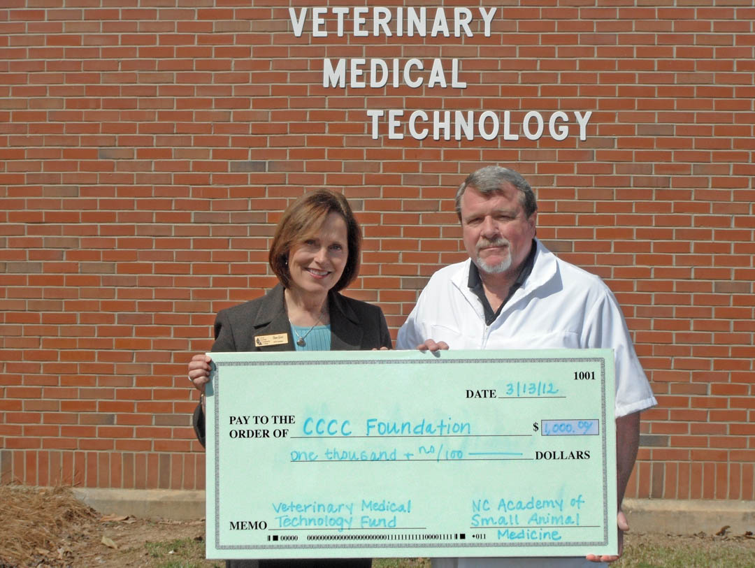 Click to enlarge,  Diane Glover (left), executive director of the Central Carolina Community College Foundation, and Dr. Paul Porterfield, chairman of the college's Veterinary Medical Technology program, proudly display a $1,000 check donated to the program's Restricted Fund by the North Carolina Academy of Small Animal Medicine. Porterfield is a NCASAM board member and the organization made the donation to honor him on his retirement from the college after more than 18 years of service. The VMT program uses the Restricted Fund for special and/or emergency needs. For more information on the VMT program, visit the college's Web site,  www.cccc.edu . For more information on making a charitable donation to CCCC, contact Glover at (919) 718-7231 or  dglover@cccc.edu . 