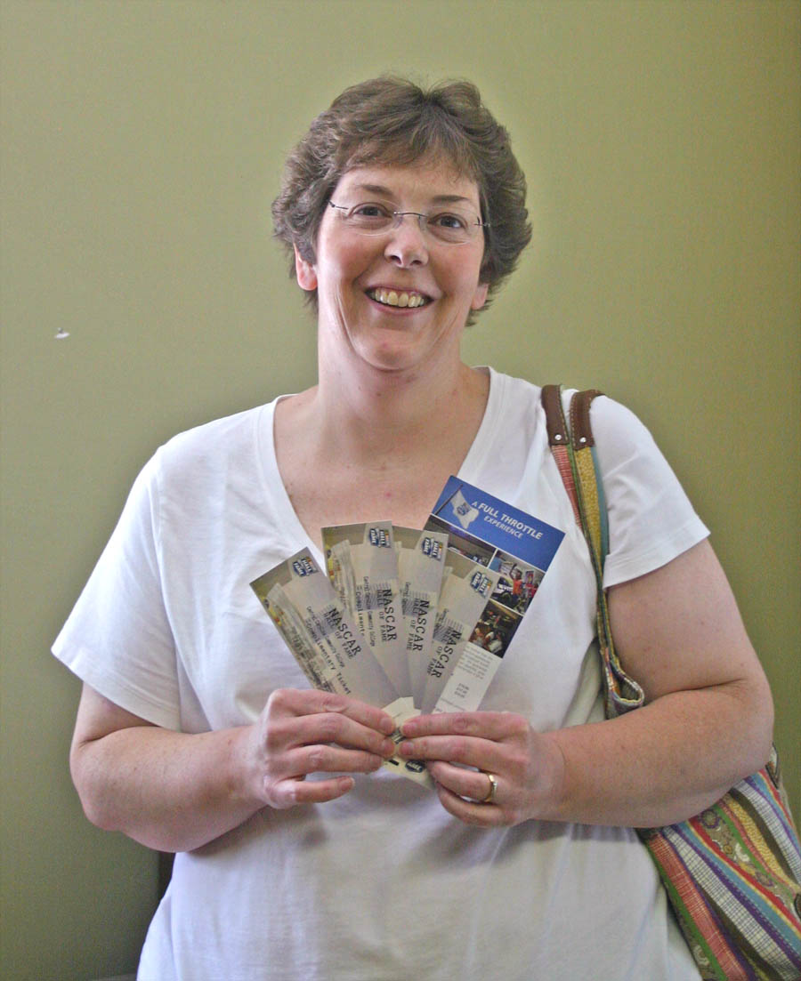 Click to enlarge,  Central Carolina Community College student Stella Bridges, of Sanford, is all smiles as she holds the NASCAR Hall of Fame tickets she won in one of the college's drawings celebrating its 50th Anniversary. Bridges and her husband, Jay, are really big NASCAR fans. They and their daughter, Autumn, are looking forward to visiting the Hall of Fame, in Charlotte. Bridges, who is earning an Associate in Arts degree, is an accountability assistant for Lee County Schools. For more information about the college's 50th Anniversary celebration during the 2011-12 school year, visit  www.cccc.edu/50years . 