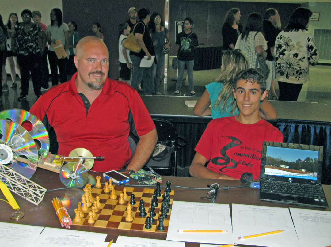 Click to enlarge,  Rodney Schmitz (left), Lee Early College Competition Clubs advisor, and Andrew Ruiz, LEC senior, were available to chat with potential Competition Clubs members during LEC's seventh annual Freshman Orientation, held Aug.1 at the Dennis A. Wicker Civic Center. Lee Early College, a collaboration of Lee County Schools and Central Carolina Community College, is located on the college's Lee County Campus. LEC students earn a high school diploma and associate degree, at no cost, within five years.  