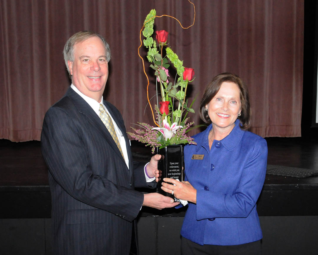 Click to enlarge,  Central Carolina Community College President Bud Marchant (left) presents a vase of flowers to Diane Glover, retiring executive director of the CCCC Foundation, during the foundation's 2012 Scholarship Luncheon Nov. 16 in the Dennis A. Wicker Civic Center.  Glover retires as of Jan. 1 after serving as foundation director since 2003 and the assistant director for two years prior to that. Under her leadership, the college's scholarship endowments grew from $1.5 million to $3.5 million and the total amount of scholarships awarded, from $60,000 to $175,000. The CCCC Foundation is a 501(c)(3) charitable organization affiliated with, but independent of the college. It receives donations of money and equipment on behalf of CCCC and uses them to promote the educational mission of the college and assist students through scholarships and grants. For information on establishing scholarships or endowments, contact Glover (through Dec. 31), at 919-718-7231 or dglover@cccc.edu, or Associate Director Emily Hare, 919-718-7230 or ehare@cccc.edu. 