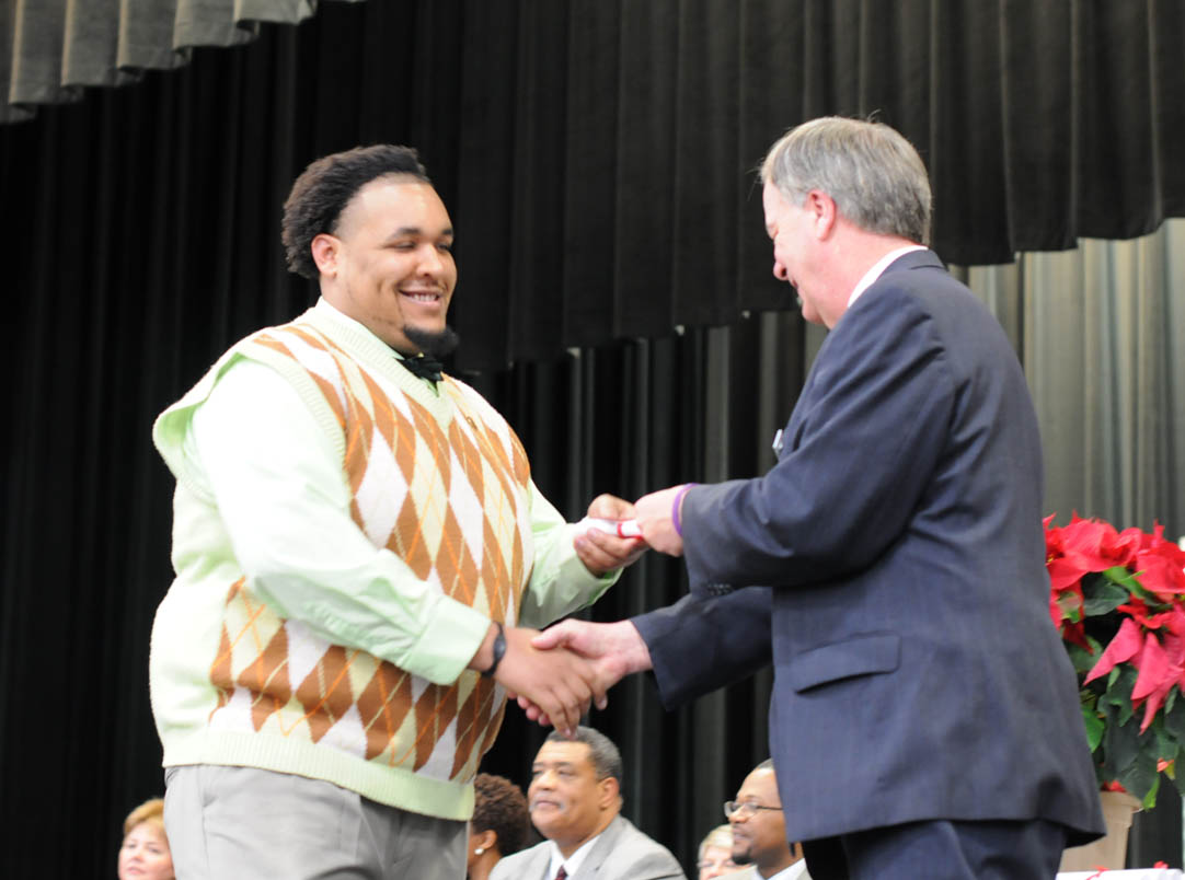 Click to enlarge,  Chatham graduate   LaFayette Williams, of Chatham County, receives his Phlebotomy Certificate from Central Carolina Community College President Bud Marchant during the college's Continuing Education Medical Programs Graduation Dec. 13 at the Dennis A. Wicker Civic Center. The graduation was the largest Con Ed Medical Programs graduation the college has ever had, with more than 200 students and approximately 1,100 friends and family filling the Dennis A. Wicker Civic Center's main hall.  