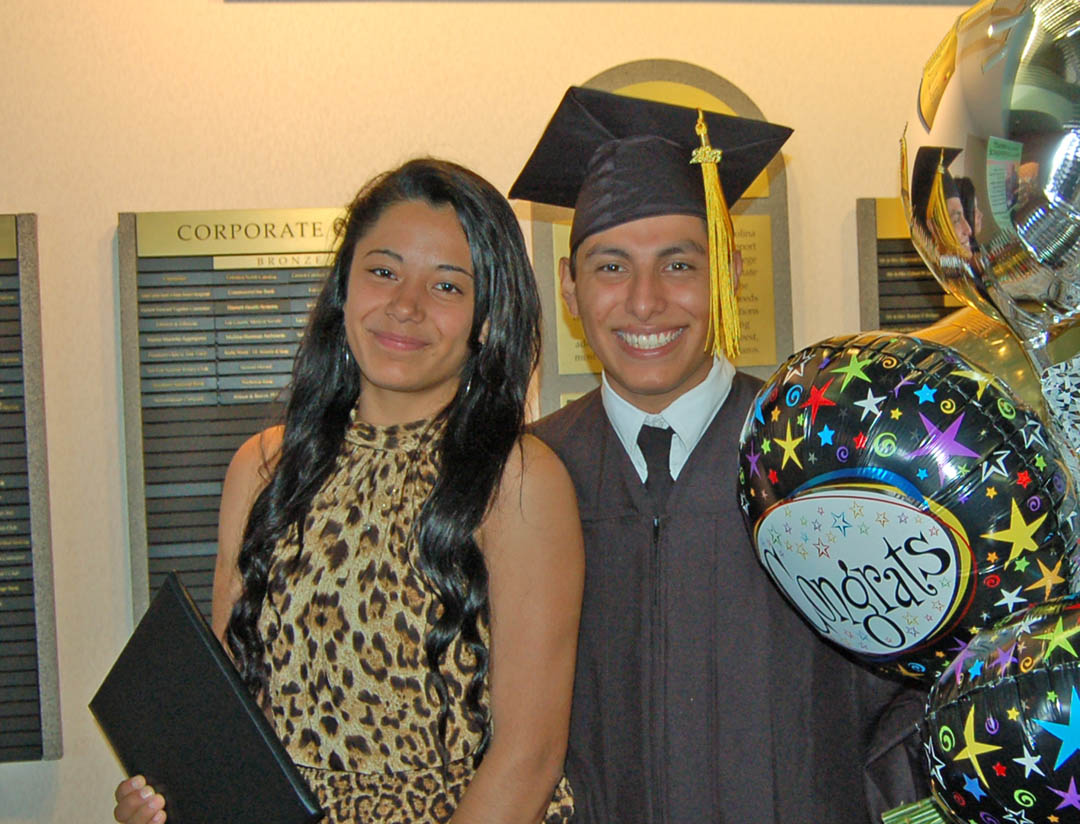 Click to enlarge,  Fernando Estrada (right), of Lee County, and his girlfriend, Mariela Sanchez, are all smiles following his Aug. 6 graduation from Central Carolina Community College. Estrada received his Associate in Applied Science in Industrial Systems Technology. The graduates earned more than 400 degrees, diplomas and certificates, with some students earning more than one. Some will continue their education at four-year institutions, while most will take their new skills and knowledge directly into the workplace. For information about programs at CCCC, visit www.cccc.edu/. 