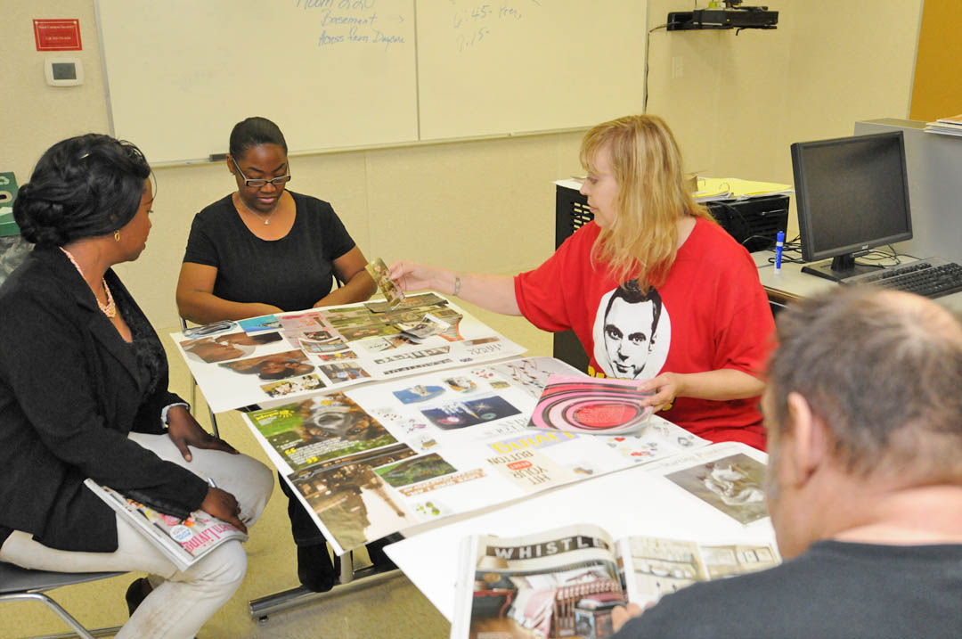 Click to enlarge,  Crystal McIver (left), Central Carolina Community College Fresh Start program instructor, encourages students (from second left) Faye McAuley, Madeleine Bassi, and Terry Mann, all of Lee County, as they work on vision boarding. Fresh Start assists former law offenders in developing positive thinking, communication, healthy self-esteem, and goal setting skills. It also trains them to present themselves positively to potential employers. Creating individual vision boards encourages them to look forward and dream big. For more information about the Fresh Start program at CCCC, contact Crystal McIver at the Lifelong Learning Center at W.B. Wicker, 919-777-7798 or by e-mail at cmciv653@cccc.edu.  