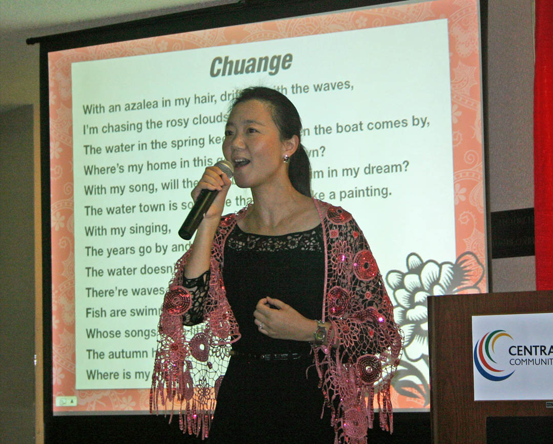 Click to enlarge,  Ling Huang, Confucius Classroom instructor for Central Carolina Community College from 2011-13, sings 'Chuange' (The Boat) love song during a reception for 'Traditions of China,' an exhibition of works by Chinese photographer Yong Xiao. The exhibition was one of several events Huang organized or participated in during her time at the college. She recently returned home to her family and friends and her position as an English instructor at Nanjing Normal University, The People's Republic of China. The Confucius Classroom is a partnership with N.C. State University's Confucius Institute. For more information about Central Carolina Community College's Confucius Classroom, visit www.cccc.edu/confucius. 