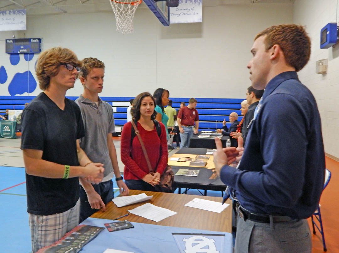 Click to enlarge,  Joe Petrizzi (right), University of North Carolina-Chapel Hill admissions representative, speaks to Central Carolina Community College students (from left) Logan Ellis, Hunter Jones, and Nathalia Cruz, all of Sanford, during the college's Dec. 6 University Transfer Day. The event, held in the Lee County Campus gym, attracted representatives from 20 four-year colleges and universities. All were eager to tell the approximately 200 students who attended what their schools offer, what they look for in applicants, how to apply, and to answer any questions the students had. For more information about university transfer programs at CCCC, visit www.cccc.edu/admissions/audience/transfer/. 