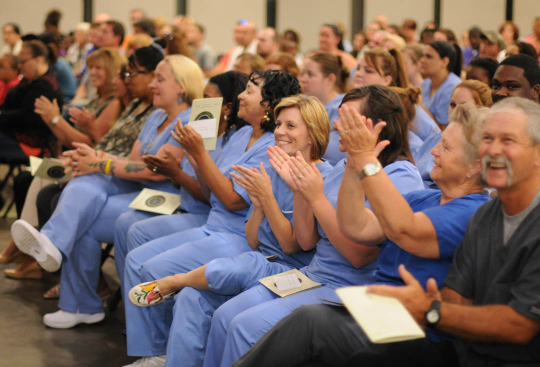 Click to enlarge,  Happy graduating students applaud during their May 29 Continuing Education Medical Programs Graduation at Central Carolina Community College's Dennis A. Wicker Civic Center. More than 300 completed their studies during the spring semester in the fields of Nurse Aide I and II, EKG Technician, Phlebotomy Technician, Pharmacy Technician, Central Sterile Processing Technician, and Sleep Disorder Technician. Approximately 200 took part in the graduation ceremony. For more information about Continuing Education medical programs, call Lennie Stephenson, 910-814-8833 or email lstephenson@cccc.edu in Harnett County; Heike Johnson, 910-545-8682 or hjohnson@cccc.edu in Chatham County; or Joy McPhail, 919-777-7787 or jmcphail@cccc.edu in Lee County. 