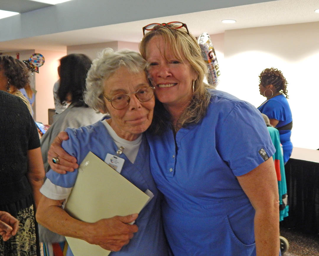Click to enlarge,  Donna Huff (left) and Michelle Hancock, both of Chatham County, share a congratulatory hug after receiving their Nurse Aide I certificates during the Central Carolina Community College's May 29 Continuing Education Medical Programs Graduation at the Dennis A. Wicker Civic Center. More than 300 completed their studies during the spring semester in the fields of Nurse Aide I and II, EKG Technician, Phlebotomy Technician, Pharmacy Technician, Central Sterile Processing Technician and Sleep Disorder Technician. Approximately 200 took part in the graduation ceremony. For more information about Continuing Education medical programs, call Lennie Stephenson, 910-814-8833 or email lstephenson@cccc.edu in Harnett County; Heike Johnson, 910-545-8682 or hjohnson@cccc.edu in Chatham County; or Joy McPhail, 919-777-7787 or jmcphail@cccc.edu in Lee County. 