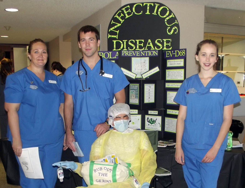 Click to enlarge,  These Central Carolina Community College nursing students - Shannon Burrous, Brian Rupp and Natalie Giles - greeted visitors to the "Infectious Disease" booth at the Lee County Schools/Central Carolina Community College Employee Health &amp; Benefits Fair on Nov. 4 at the Dennis A. Wicker Civic Center in Sanford. For more information on the CCCC nursing program, call 919-718-7461 or go to the college website at www.cccc.edu. 