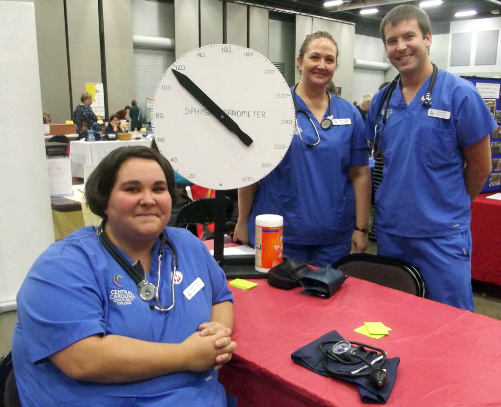 Click to enlarge,  These Central Carolina Community College nursing students - Heather Strickland, Shannon Burrous and Brian Rupp - checked blood pressures at the Lee County Schools/Central Carolina Community College Employee Health &amp; Benefits Fair on Nov. 4 at the Dennis A. Wicker Civic Center in Sanford. For more information on the CCCC nursing program, call 919-718-7461 or go to the college website at www.cccc.edu. 
