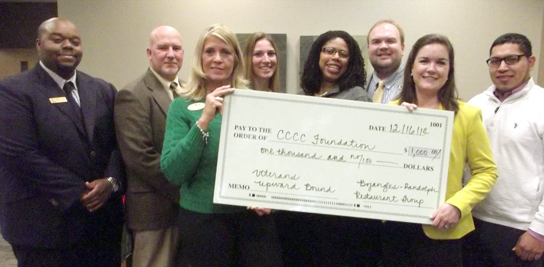 Click to enlarge,  Patti Carithers Daniels, Operations Manager for Bojangles' - Randolph Restaurant Group, and Emily Hare, CCCC Foundation Executive Director, hold the donation check to go toward the Veterans Upward Bound program. Pictured behind Daniels and Hare are, left to right: Wilson Lester, Outreach Coordinator for the Veterans Upward Bound program; Brad Johnson, a Navy veteran who is one of the scholarship recipients; Ashley Tittemore, Director of CCCC's TRiO Programs; Dr. Pamela Senegal, CCCC Vice President of Economic &amp; Community Development; Dr. Brian Merritt, Vice President of Student Learning; and Delfino Benitez, an Army veteran who is one of the scholarship recipients. For more information on the CCCC Veterans Upward Bound program, call 919-718-7463, email veteransub@cccc.edu, or visit the programs website www.cccc.edu/vub/. 