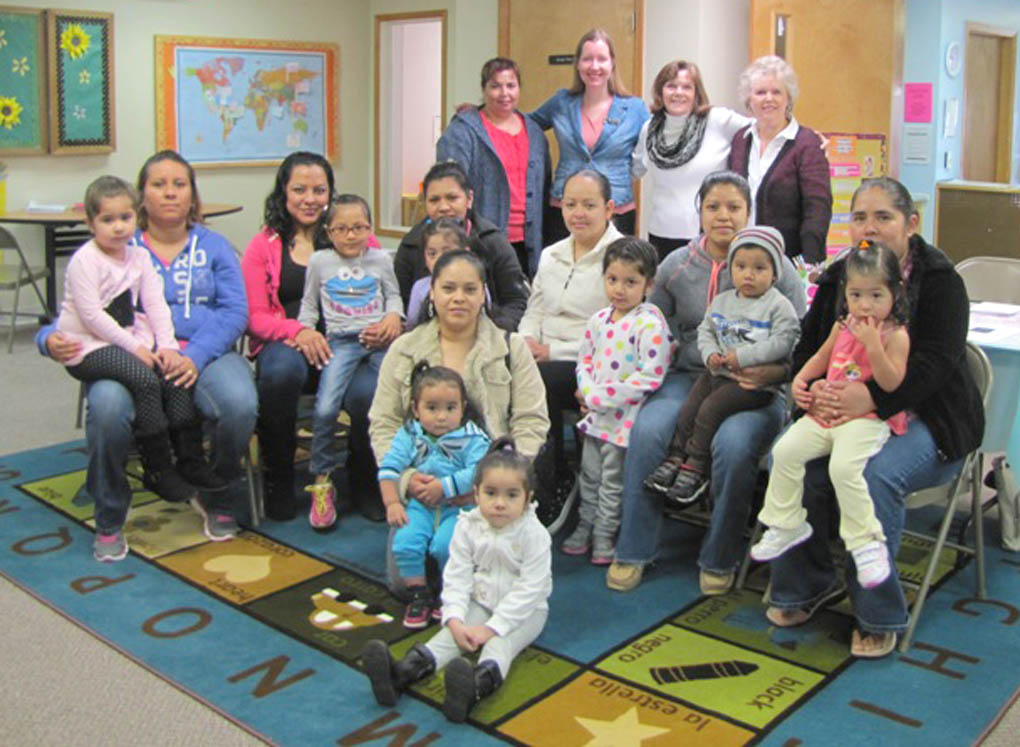 Click to enlarge,  Mothers and their children attend CCCC's Hand in Hand program at the Head Start Center in Angier. Pictured in front are the mothers with their children. Pictured on the back row are, left to right: teachers Sol Osorio, Alison Macomber, and Julia Owen, and CCCC College and Career Readiness Coordinator Melody McGee. 