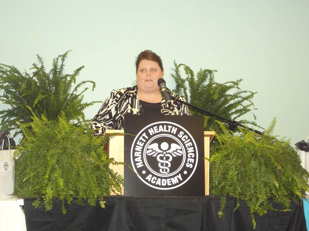 Click to enlarge,  Lynn Hartley, Harnett County Schools' Career and Technical Education Director, provides remarks at the Harnett Health Sciences Academy inaugural induction ceremony. 