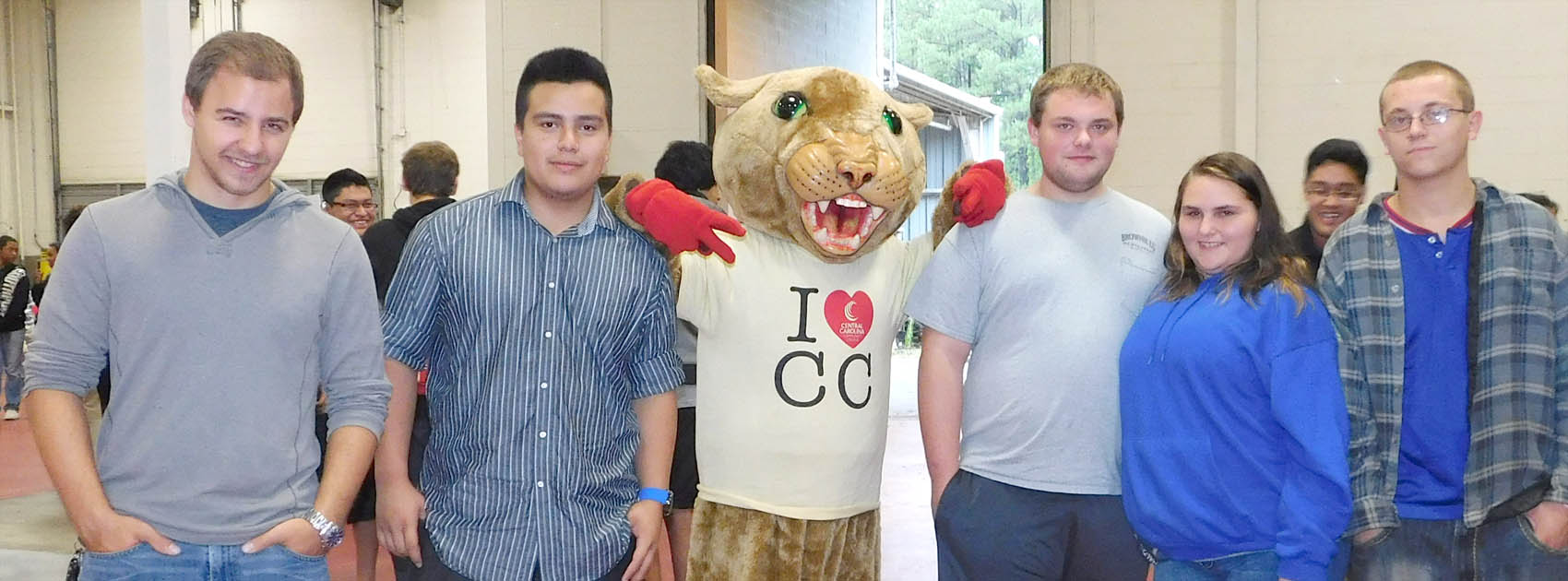 Click to enlarge,  Area students have fun with Central Carolina Community College mascot Charlee Cougar during National Manufacturing Day at CCCC's Innovation Center. 