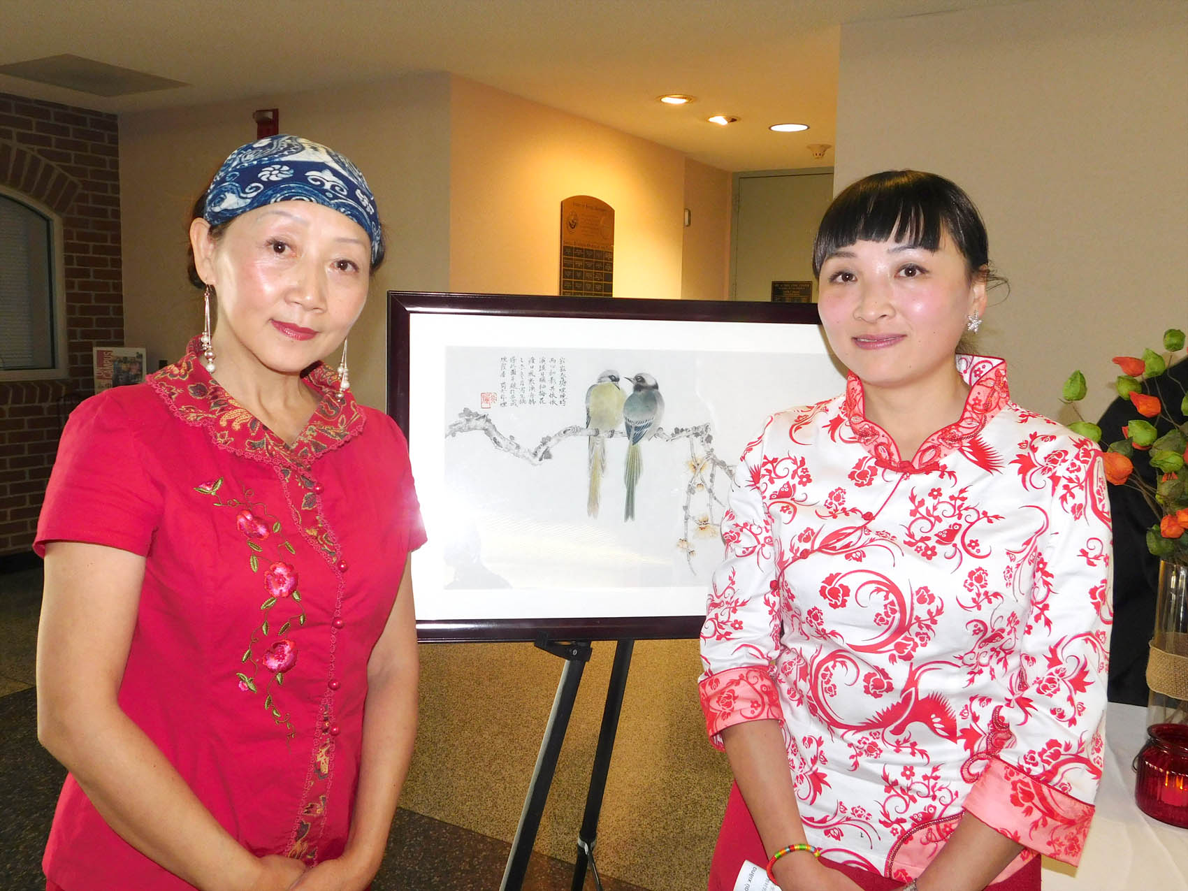 Click to enlarge,  Feiyan Liu (left) and her daughter, Guan Wang, who is the Central Carolina Community College Confucius Classroom Instructor, are pictured during the Chinese Art Exhibition held Sunday, Nov. 15, at the Dennis Wicker Civic Center. 