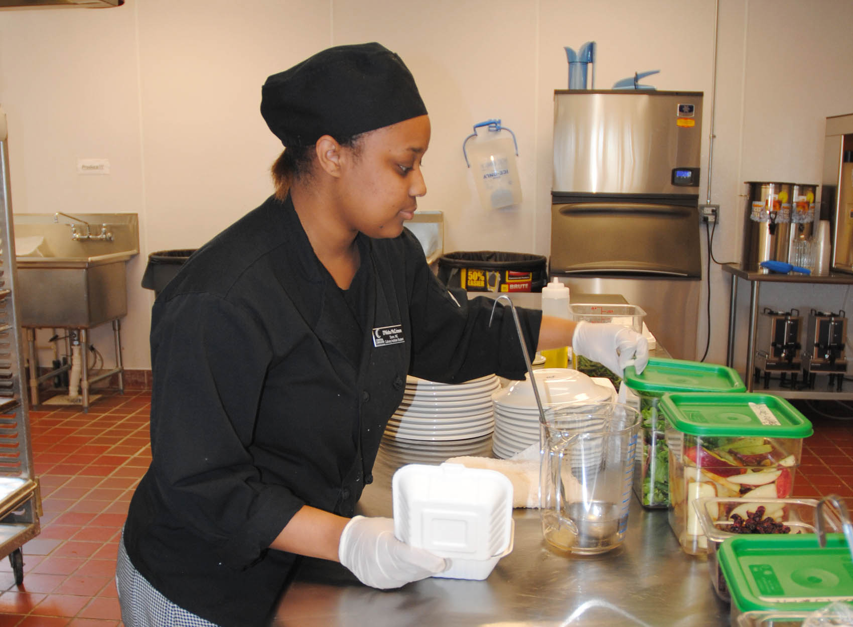 Click to enlarge,  Lisa Farmer | The Daily Record. D'Nisha McCrimmon of Dunn, CCCC culinary arts student, prepares a garden apple salad to go at the CCCC/Dunn Center.  