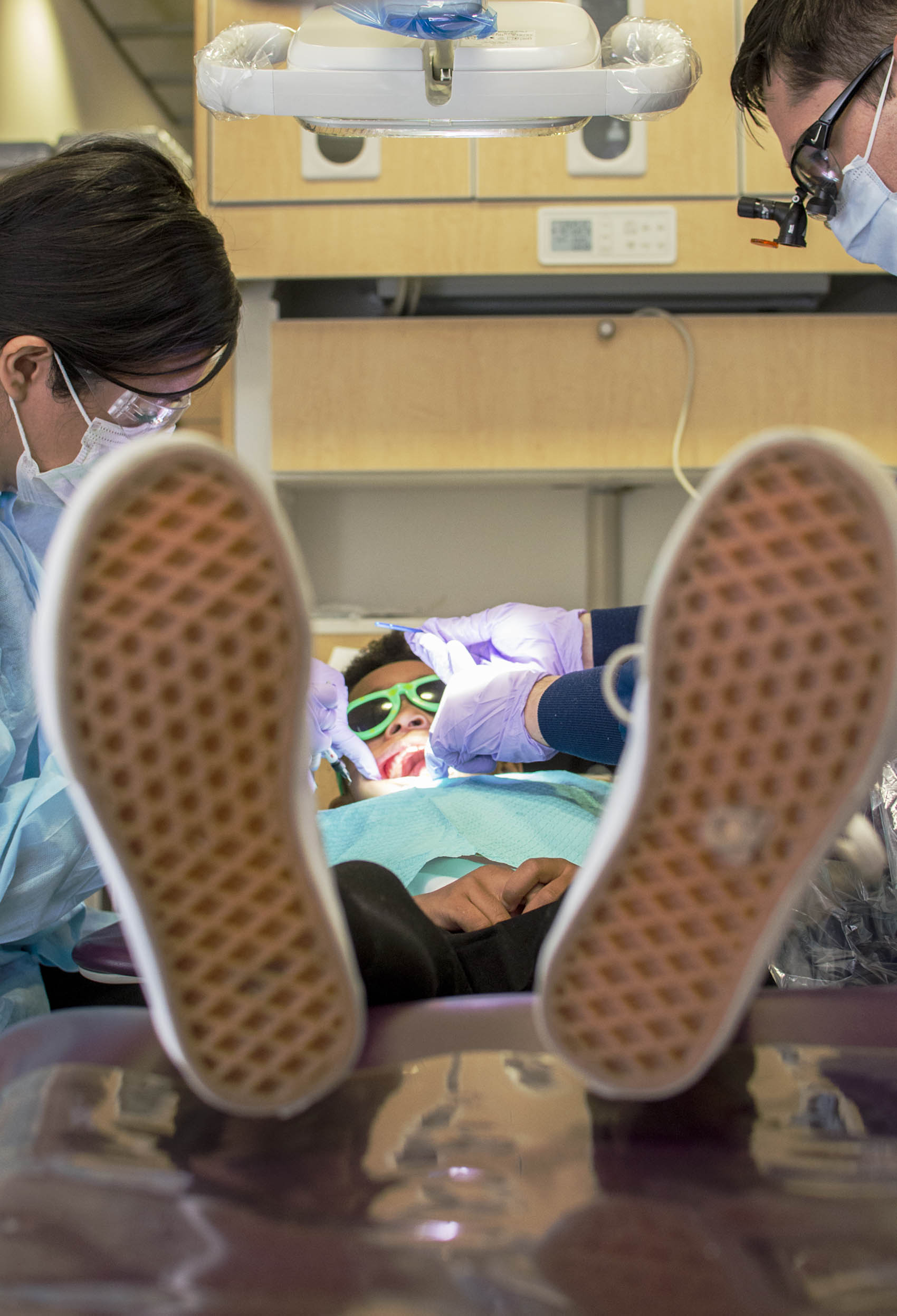 Click to enlarge,  Charlotte de Lopez, The Sanford Herald. Yazmin Reynoso (left) and Andrew Hendrick (right) work on the teeth of one individual during the Give Kids a Smile event at the Central Carolina Dental Center. 