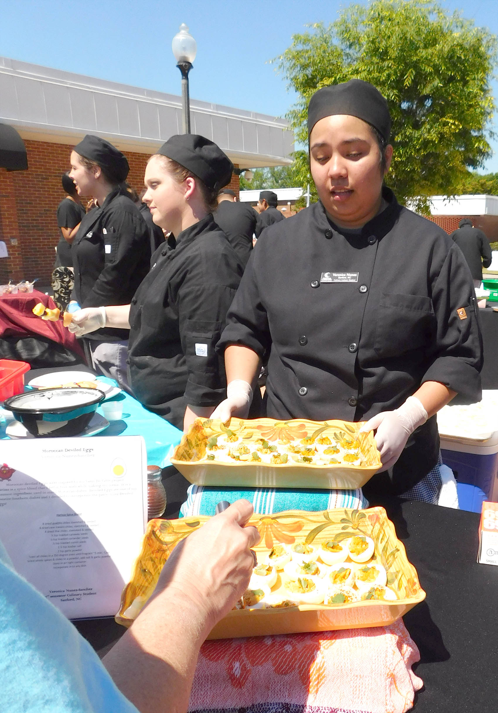 Click to enlarge,  Veronica Nunez-Sanchez, of Sanford, with her Moroccan Spiced Deviled Eggs with Cilantro garnish, was the Best of Show winner at the Second Annual Central Carolina Community College Culinary Showcase. The event, featuring dishes by Culinary &amp; Hospitality Arts students represented from Chatham, Harnett, and Lee counties, was held April 26 on the CCCC Lee Main Campus. Special judges included WRAL's Brian Shrader (host of Local Dish) and Lisa Prince (Marketing Specialist for the North Carolina Department of Agriculture and Consumer Services and Host of Flavor, NC). 