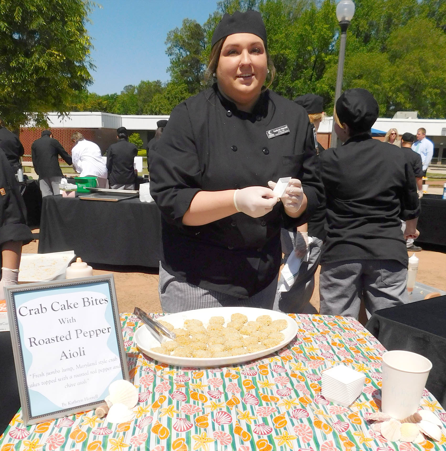 Click to enlarge,  Kathryn Horrell, of Erwin, with her Crab Cake Bites with Roasted Pepper-Chive Aioli, was the People's Choice Award winner at the Second Annual Central Carolina Community College Culinary Showcase. The event, featuring dishes by Culinary &amp; Hospitality Arts students represented from Chatham, Harnett, and Lee counties, was held April 26 on the CCCC Lee Main Campus. Special judges included WRAL's Brian Shrader (host of Local Dish) and Lisa Prince (Marketing Specialist for the North Carolina Department of Agriculture and Consumer Services and Host of Flavor, NC). 