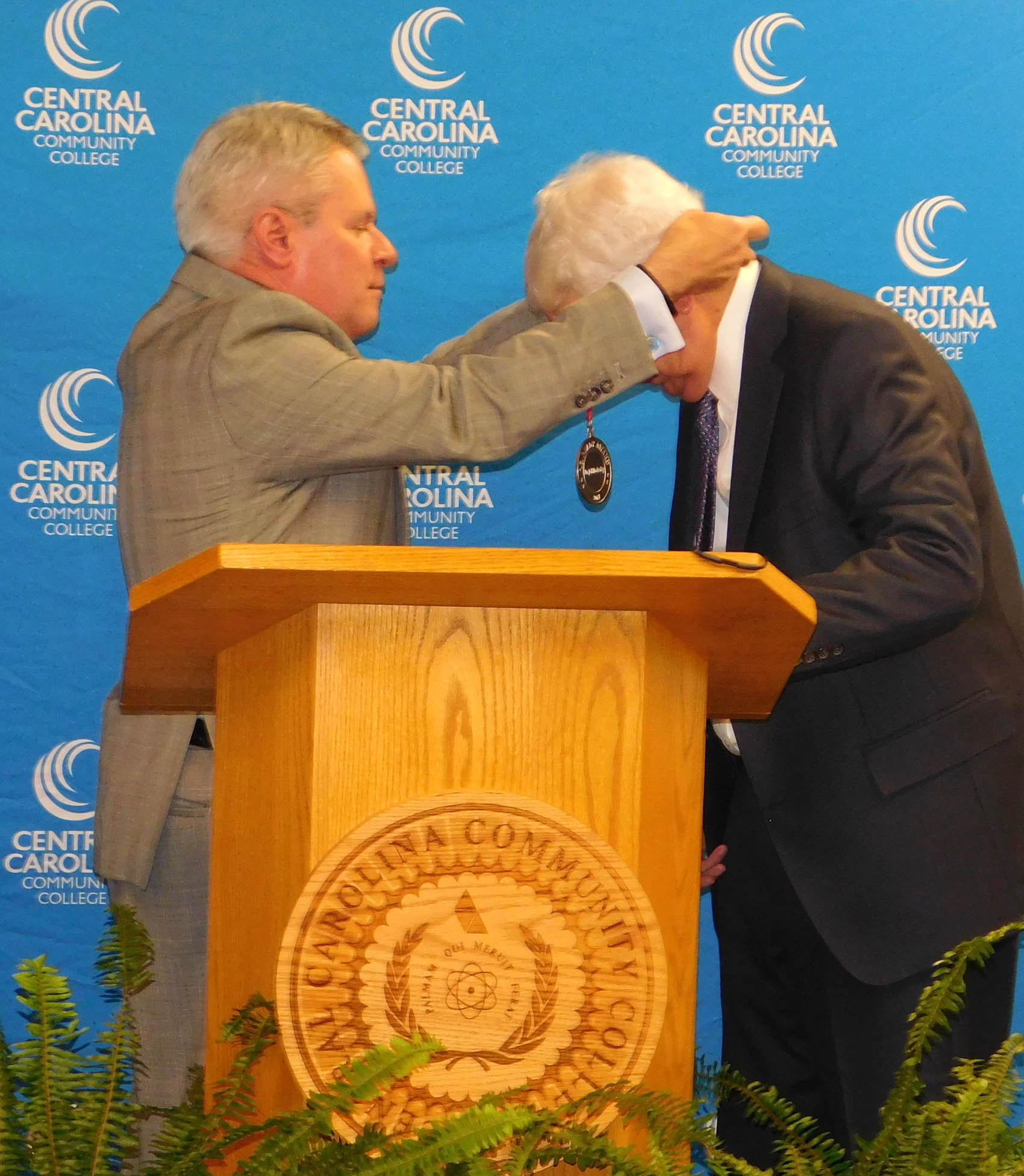 Click to enlarge,  Dr. J.F. Hockaday (right), president of Central Carolina Community College from 1969 to 1983, receives the I.E. Ready Award medal from Dr. James C. Williamson, President of the North Carolina Community College System. The I.E. Ready Award is the highest honor bestowed by the State Board of Community Colleges. 