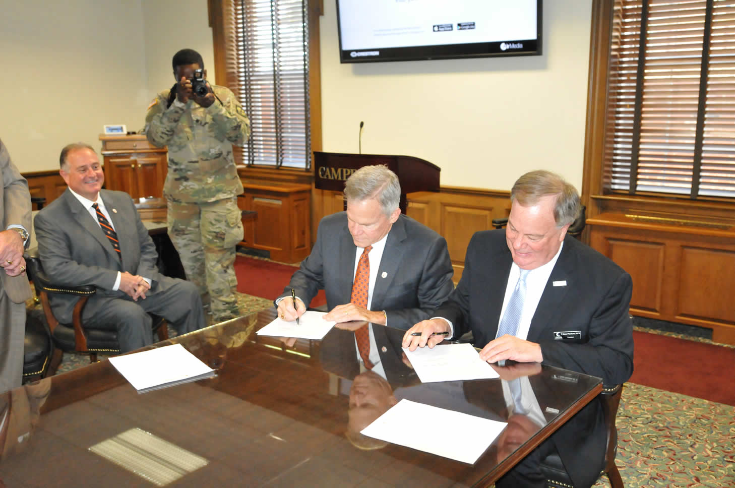 Click to enlarge,  Campbell University President J. Bradley Creed and Central Carolina Community College President Dr. T.E. Marchant sign an ROTC agreement. 