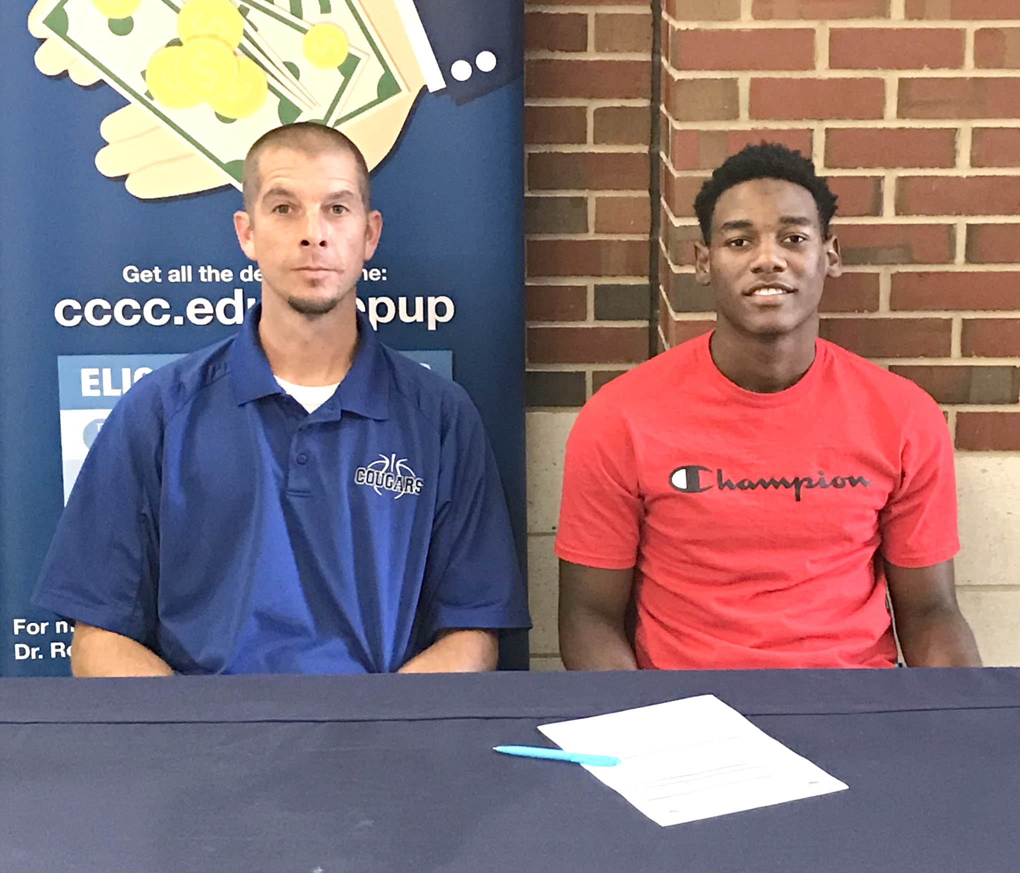 Click to enlarge,  Montell Moore (right), of Cape Fear High School, Fayetteville, recently announced his decision to join the Central Carolina Community College men's basketball program. At left is CCCC Men's Basketball Coach Brad McDougald. 