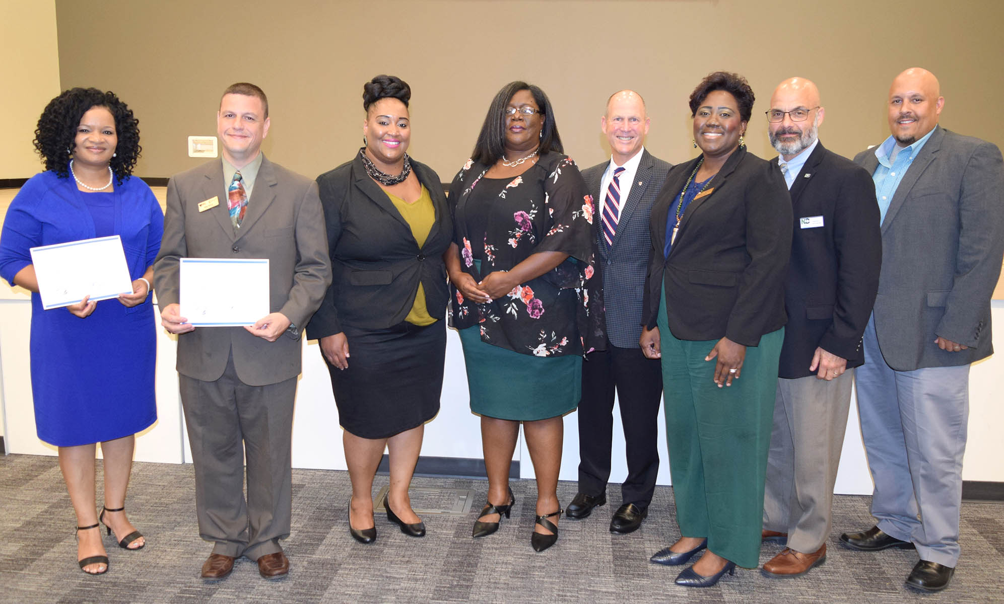 Click to enlarge,  The Triangle South Workforce Development Board (TSWDB), serving Chatham, Harnett, Lee, and Sampson counties, recently had two NCWorks Career Pathways certified by the NCWorks Commission. Pictured are, left to right: Rosalind Cross, Director of Workforce Development and WIOA Programs, TSWDB; Mike Peluso, Business Services Coordinator, TSWDB; Jessica Ingram, Business Engagement Coordinator, TSWDB; Angela Nicholson, Youth Program Coordinator, TSWDB; Kevin Trapani, NCWorks Commission Chairman; Kim Shaw, Adult Services Coordinator, TSWDB; Scott Panagrosso, Career Pathways Facilitator; and John Lowery, Regional Operations Director, Sandhills Region. 