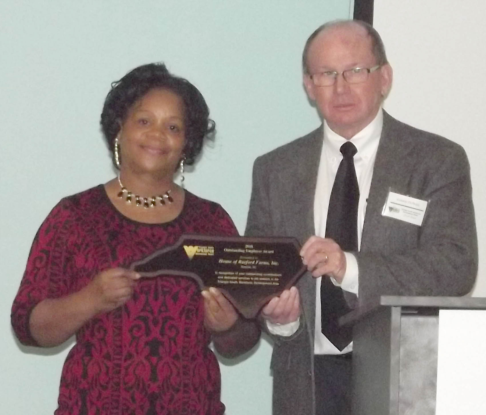 Click to enlarge,  House of Raeford Farms, Inc., received the Outstanding Employer Award at the 7th Annual Triangle South Workforce Development Board (TSWDB) Awards Banquet held Wednesday, Dec. 5, at the Central Carolina Community College Harnett Health Sciences Center in Lillington. Sandra Webster (left), NCWorks Career Center Manager - Sampson County, received the award on behalf of House of Raeford Farms, Inc. Presenting the award was Lonnie McPhail, TSWDB Member. 